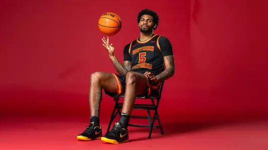 KJ Lewis poses in a chair during a men's basketball recruit shoot