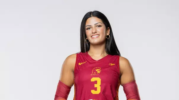 Freshman outside hitter Layli Ostovar holding a volleyball in front of a white background.