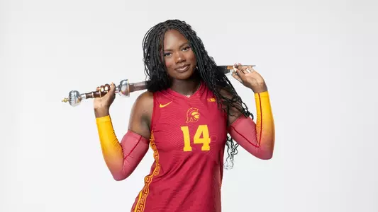 Freshman middle blocker Taliyah Hanks holds sword in front of white background.