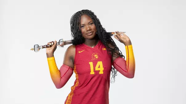 Freshman middle blocker Taliyah Hanks holds sword in front of white background.