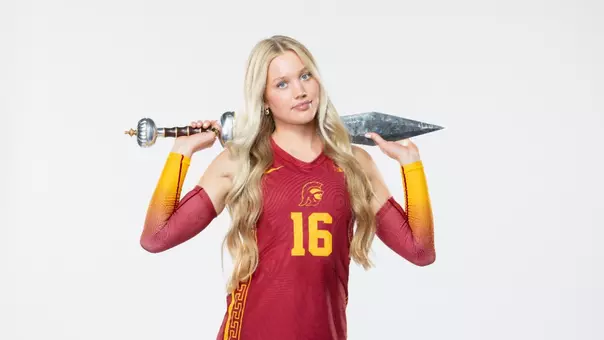 Lilli Etter holding Trojan sword in front of white background for media day