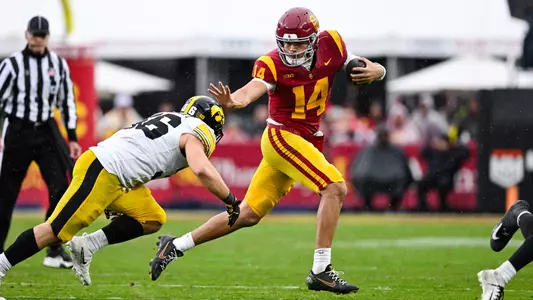 USC quarterback Jayden Maiava stiff arms a defender.