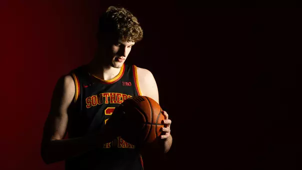 Eric Reibe looks at a basketball during a recruit shoot