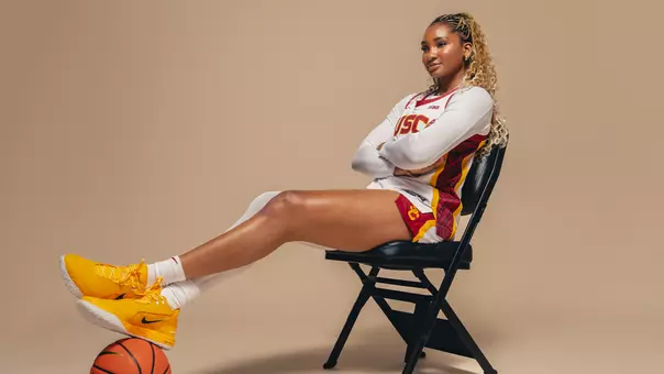 Kiki Iriafen USC WBB poses on a chair
