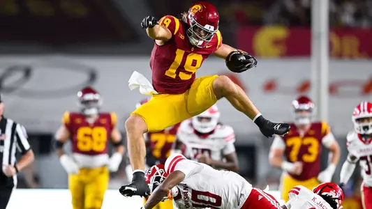 Mark Bowman hurdles two Louisiana defenders.