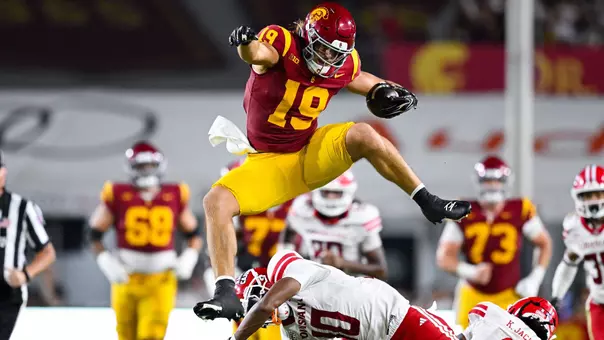 Mark Bowman hurdles two Louisiana defenders.