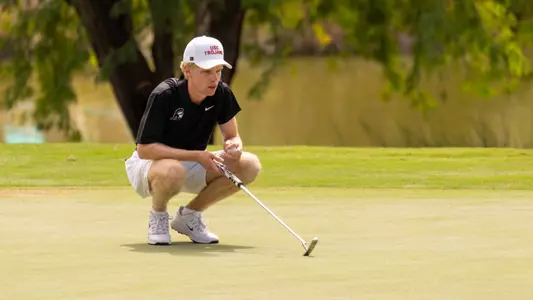 Hendrik-Luka Schmitz surveys the green at the Bombs Darts Birds Collegiate
