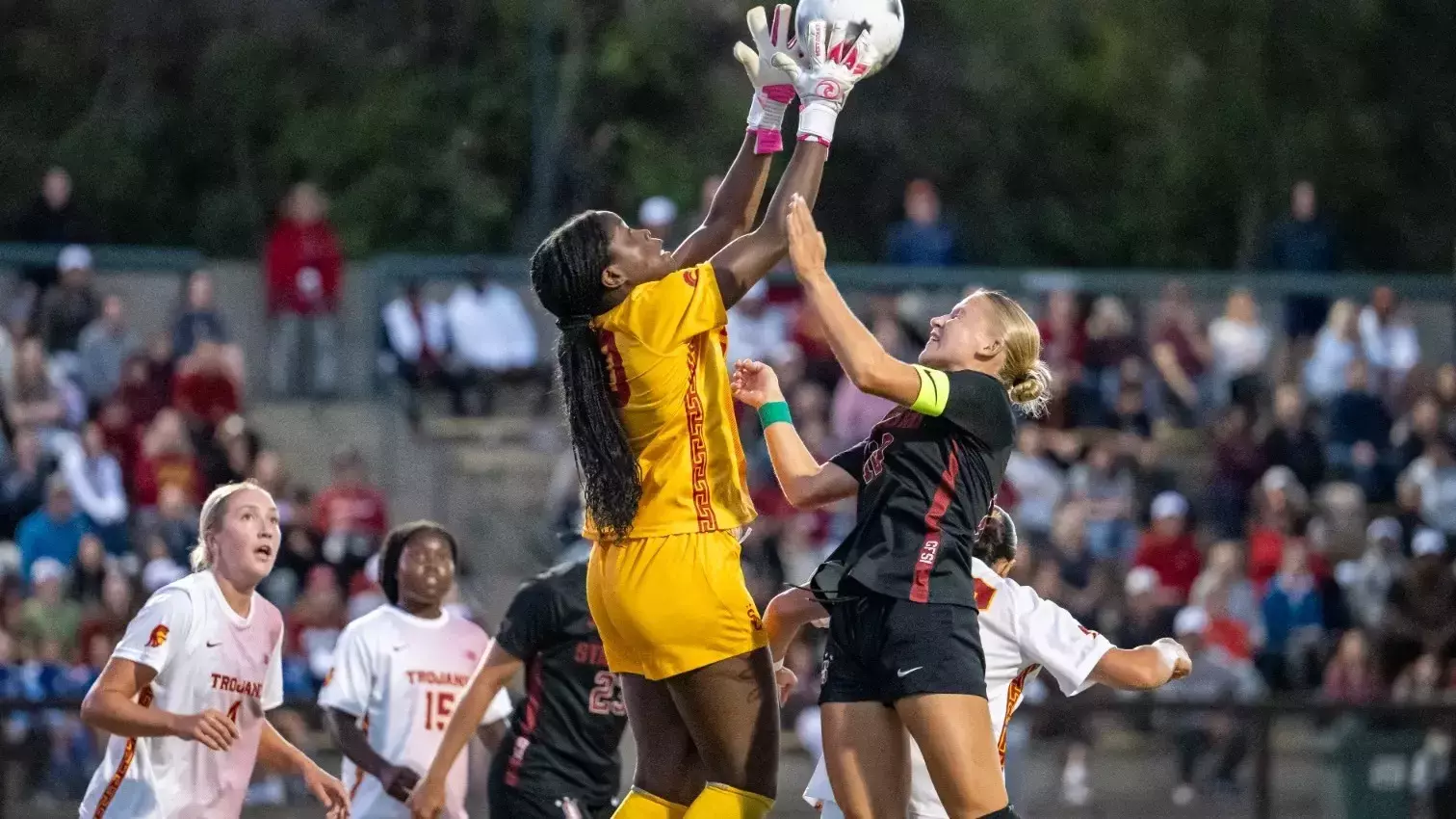 Josie Biehl fights for a ball in the air against a Stanford player.