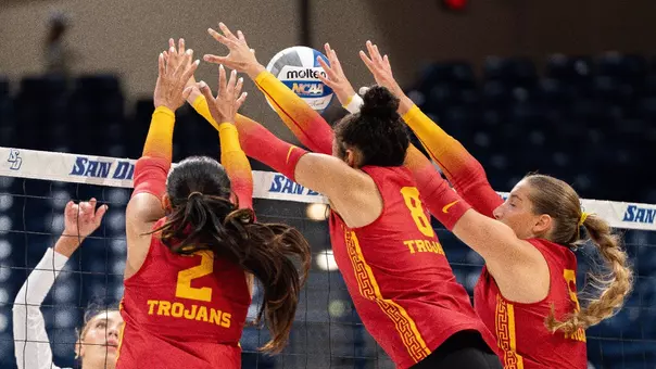 USC women's volleyball players London Wijay, Mia Tvrdy, and Abigail Mullen go up to block an attack by the Toreros during a match at Jenny Craig Pavilion in San Diego, Calif.