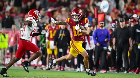 USC Trojans Football wide receiver Corey Simms stiff-arms Fresno State Bulldogs defender