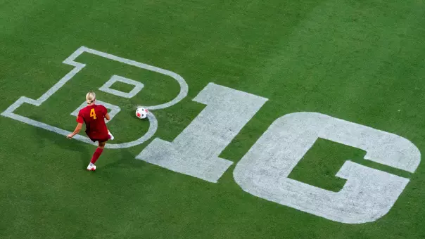 Hadley Snyder sends a pass across the Big Ten logo at Rawlinson Stadium.