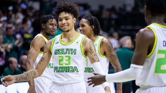 Caleb smile with team 112421 MBB v HAM