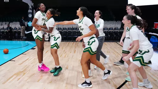 WBB team celebration after Harvard in the Bahamas
