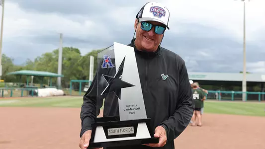 Ken Eriksen holding 2025 AAC Tournament Trophy