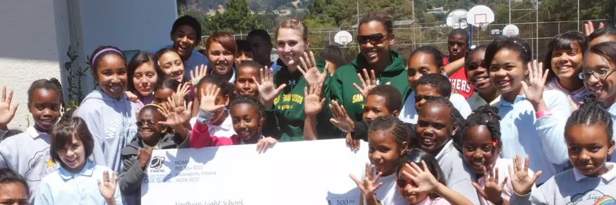 Women's Basketball Presents Check To Northern Light School Image