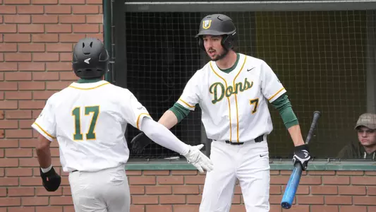 Logan Leax high-fiving Tyvon Moore