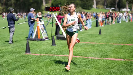 Anna Büttner crossing finish line at USF Invite