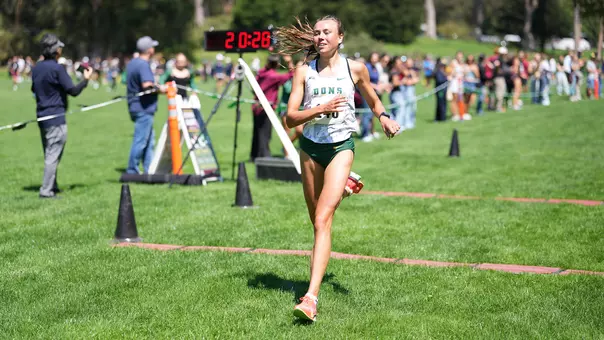Anna Büttner crossing finish line at USF Invite