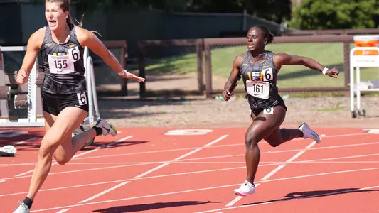 Sophia Preister-Veasley handing off a baton at Payton Jordan Invite 2024