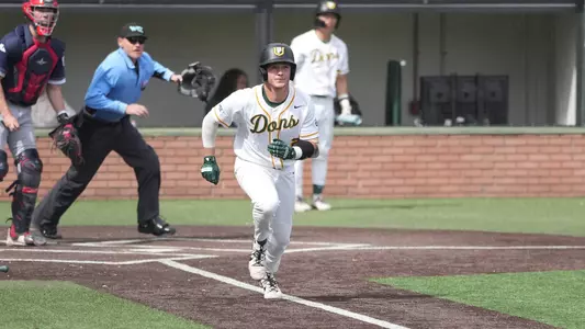 Myles Kallinger running down the first base line vs. SMC
