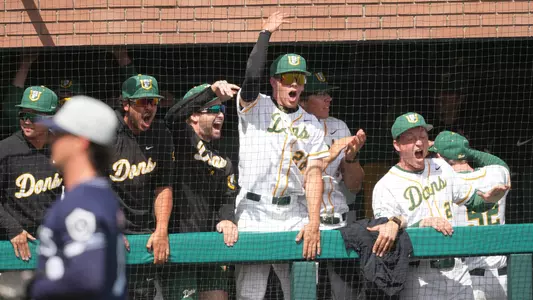 Nick Walsh and teammates celebrating in the dugout vs. SMC