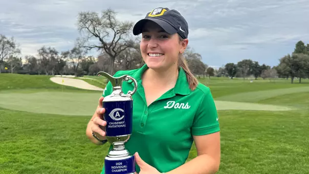 Eva Pett holding the Causeway Invitational trophy
