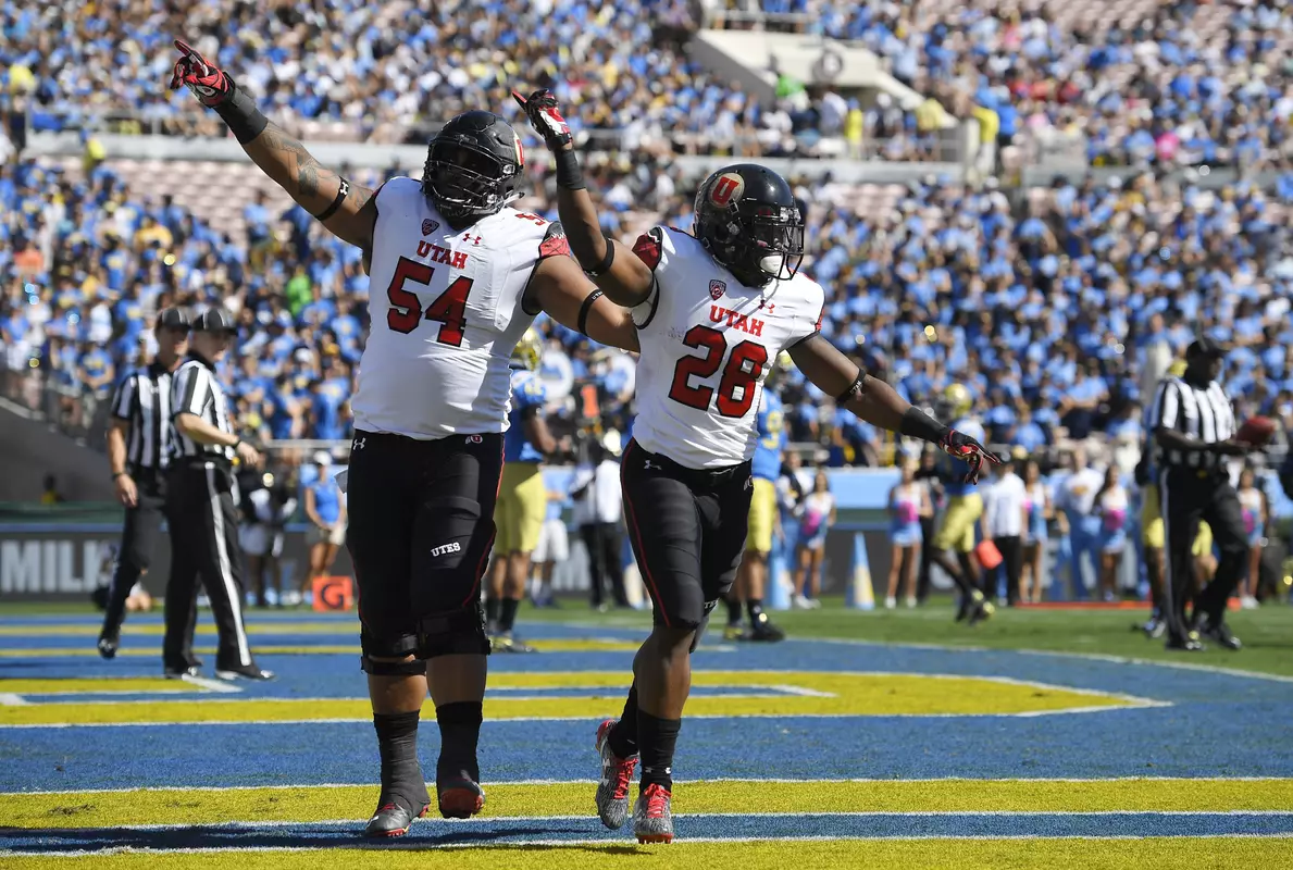 Utah running back Joe Williams, right, celebrates his touchdown with offensive lineman Isaac Asiata during the first half of an NCAA college football game against UCLA, Saturday, Oct. 22, 2016, in Pasadena, Calif. (AP Photo/Mark J. Terrill)