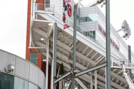 The ceremonial final beam is raised as part of the construction of the Ken Garff Performance Zone at Rice-Eccles Stadium, after being signed by many.