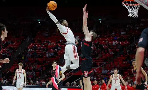 SALT LAKE CITY, UT - FEBRUARY 29 : Deivon Smith #5 of the Utah Utes flies in the air to slam dunk over Michael Jones #13 of the Stanford Cardinal during the second half of their game at the Jon M Huntsman Center on February 29, 2024 in Salt Lake City, Utah. (Photo by Chris Gardner/Getty Images)