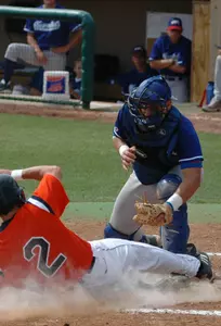 Catcher Adam Moore tags out a runner at home plate on Saturday