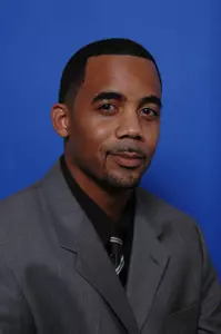 Reggie Brown has been promoted to associate head coach of the men's basketball team.