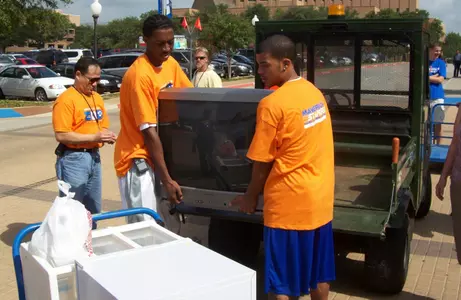 LaMarcus Reed (left) and Rog'er Guignard (right) help move students into Kalpana Chawla Hall