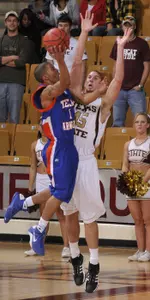 Roge'r Guignard drives past Texas State's Dustin Moseley in the Mavericks 87-76 loss Saturday.