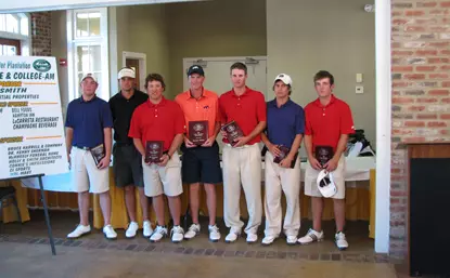 Zack Fischer (center) displays his first place trophy.