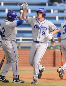 Blake Holt is congratulated after hitting a home run to lead off the bottom of the 1st inning.