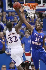 Brandon Edwards goes up for a block shot against Kansas.