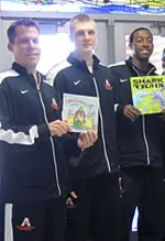 Head coach Scott Cross, Karol Gruszecki and LaMarcus Reed helped read to students.