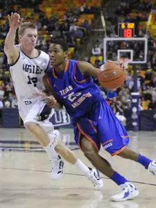 Cameron Catlett drives to the basket against Utah State Tuesday in the Mavs 73-69 loss.