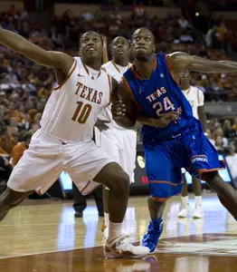 Kevin Butler fights with Jonathan Holmes for a rebound Tuesday night in Austin.
