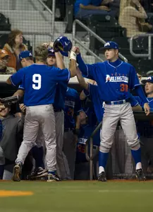 Brandon Lawrence (9) receives congratulations from his teammates as he returns to the dugout in the Mavericks 7-5 win over 12th-ranked Texas.