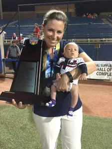 UT Arlington coach Kristie Fox and her son, Andy, with the championship trophy.