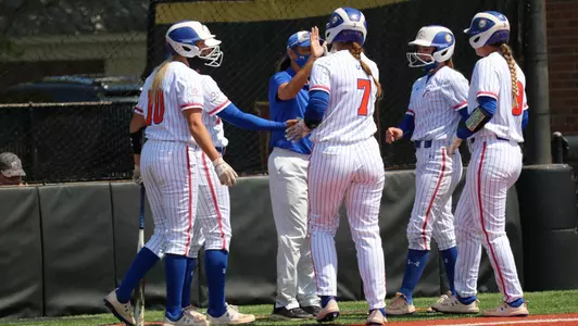 Head Coach Peejay Brun high-fiving players in ULM series game on April 3.