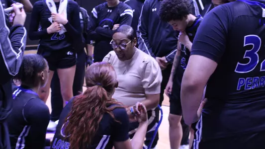 Coach Wright Drawing Up A Play On The Bench