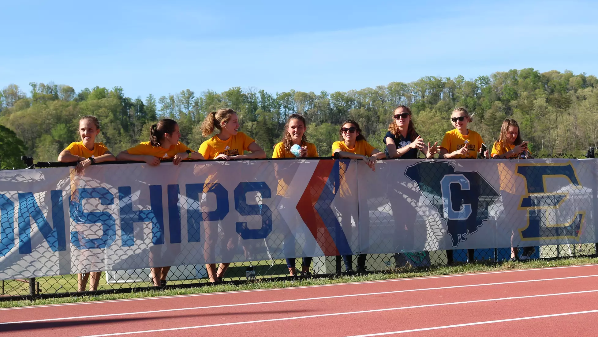 The team cheers on Faith Brown in her first-ever 3000m SC.