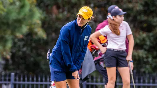 Coach Colette Murray helps read a green.