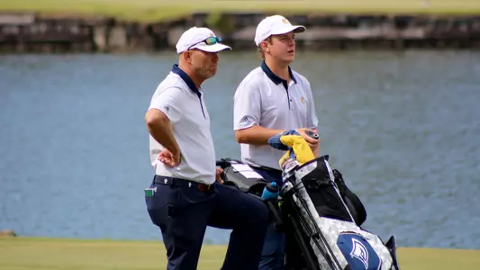 Coach Mark Guhne & A.J. Lintunen mull Lintunen's approach on 15.