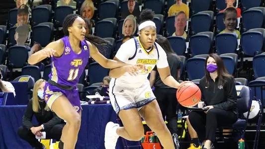 Bria Dial driving with the basketball