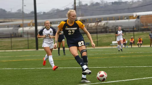 Kendra Mueller kicking the soccer ball.