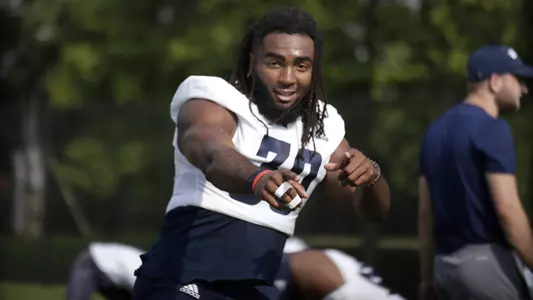 Jay Person mugs it up for the camera during pre-practice stretching.