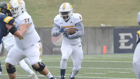 Ailym Ford follows the block of offensive guard Luke Lane at ETSU.